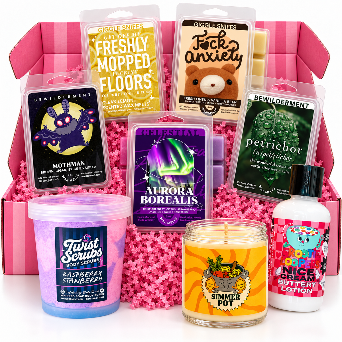 An open pink SniffCrate filled with wax melts, body scrub, a candle, and lotion